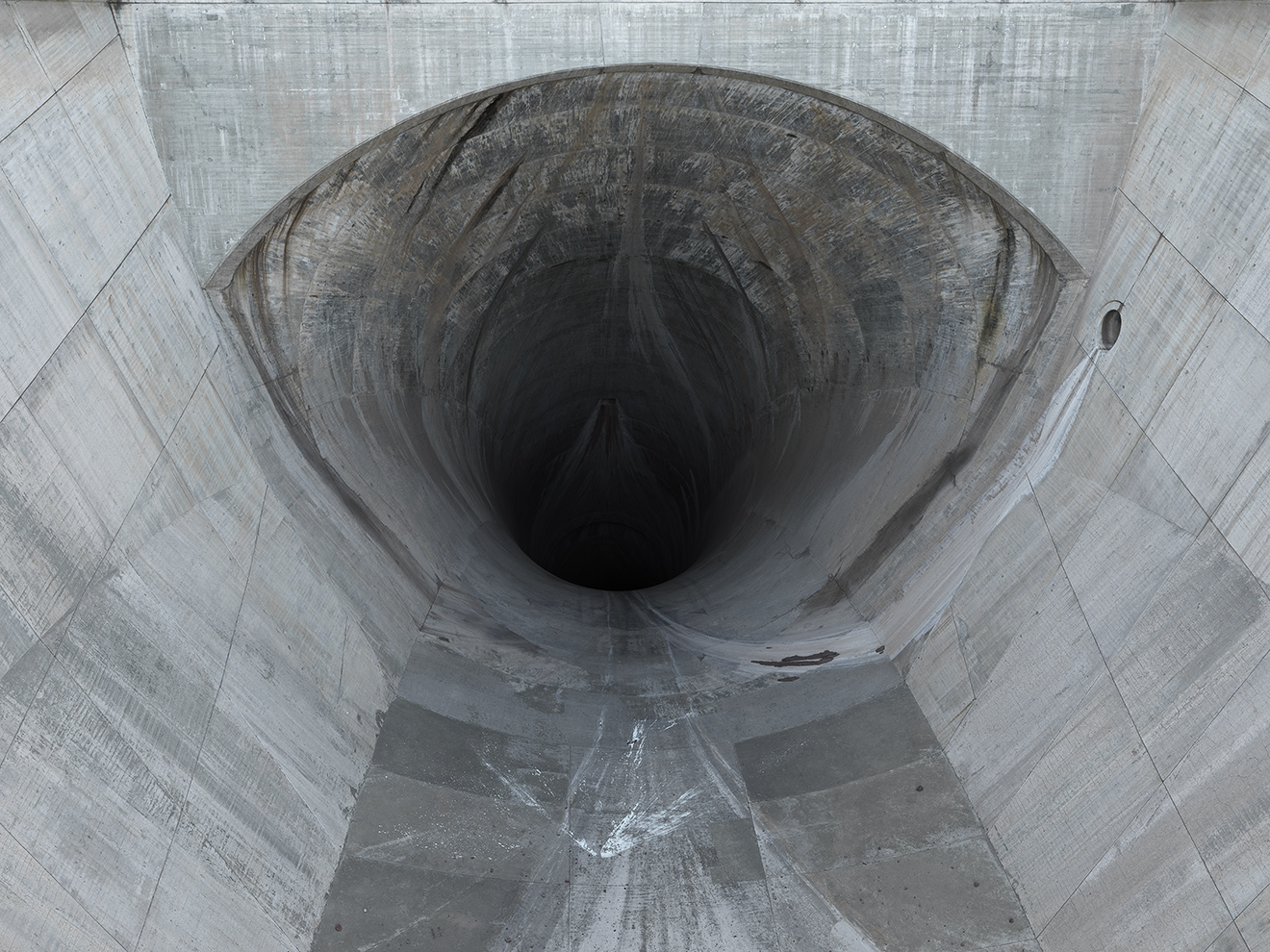 Hoover dam's spillways are connected to tunnels 15m in diameter, drilled through the rocks, that can handle 200,000 cubic feet...